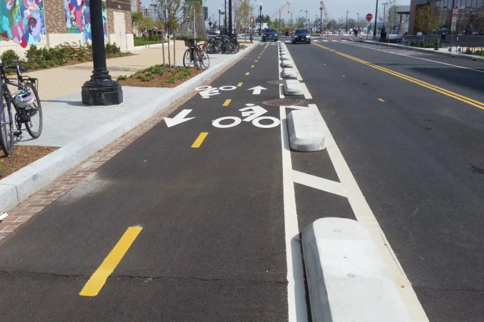 Bike lane in Washington D.C. protected by low concrete barriers.